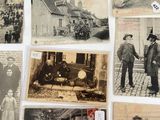 several old black and white photographs of people and vehicles on a table