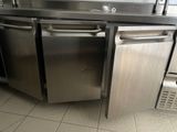 a stainless steel dishwasher in the middle of a kitchen