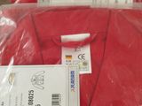 several red shirts are wrapped in plastic bags on a table