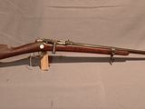 an old rifle with a wooden barrel and a wooden handle