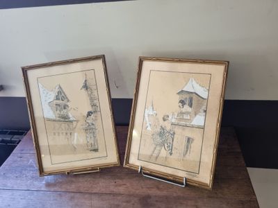 two framed pictures of people on a table