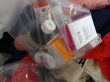 a plastic bag filled with various items on a bed