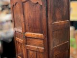 a wooden armoire in the middle of a room
