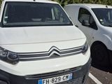 a white van parked next to a white van in a parking lot