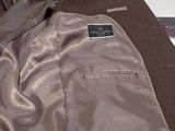 an image of a suit jacket and tie laying on a bed