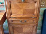 a wooden cabinet that has a drawer on top of it