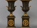 pair of black and gold vases on pedestals with numbers 50 and 50