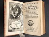 an open book with a picture of a man in a coat of arms