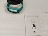 a black and green wristband with a blue band on it