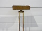brass side table with a lamp on top of it on a table