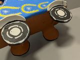 a cake shaped like a toy car on a table