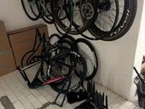 many bikes that are hanging on the wall in the garage