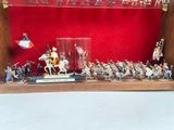 many figurines in a display case on a table