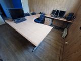 a desk with a laptop and a monitor on it