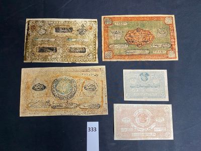 four different types of currency are on display in a glass case
