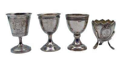 three silver goblets and spoons sitting next to each other on a white surface
