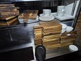 many plates and bowls on the counter in the kitchen