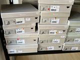 a lot of boxes that are stacked up on a shelf