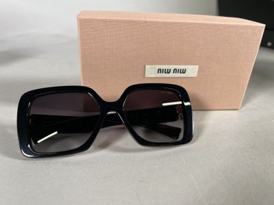 a close up of a pair of black sunglasses on a table