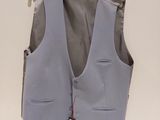 a blue vest hanging on a hanger on a wall