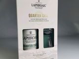 the packaging of a bottle of laphrong quartered gin next to a glass of water