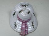 a white hat with a pink ribbon on it