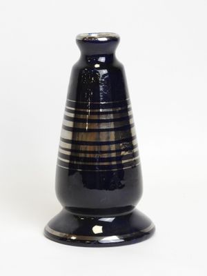 a black vase with a striped design on it