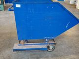 a blue dumpster sitting in a garage next to a building