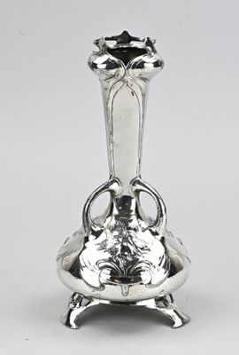 une image représentant un vase en argent posé sur une table