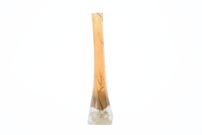 a glass vase with a wooden handle on a white surface