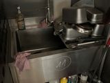 a kitchen with a sink and a stove in it