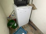 an image of a dirty kitchen with a dishwasher in the corner