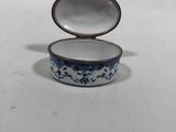 a small blue and white box on a white surface