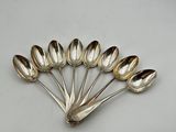 six silver spoons arranged in the shape of a flower