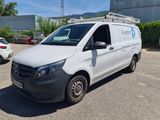 the van is parked in a parking lot with other cars