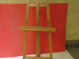 a wooden easel sitting on a white surface
