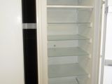 a white refrigerator with its door open in a kitchen