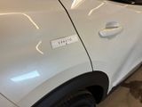 a white car with a sticker on the side of it