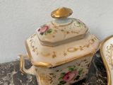a small bowl with a lid sitting on a table next to a bowl