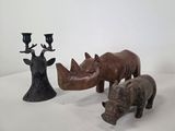 three rhino figurines sitting next to each other on a table