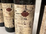 several bottles of wine are lined up on a table