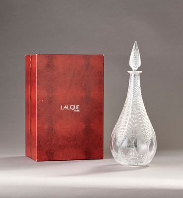an image of a glass perfume bottle next to a red box