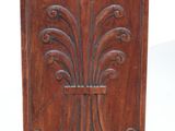 a wooden bench with a decorative design on the back
