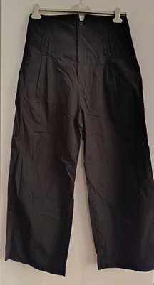 black pants hanging on a hanger in a room