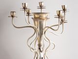 a silver candelier with five candles on it