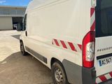 a picture of a white van parked in front of a building