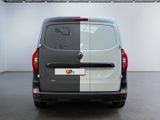 the rear of a grey van is parked in a garage