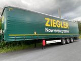 a large green truck that is parked on the side of the road