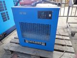 a blue machine that is sitting on a pallet