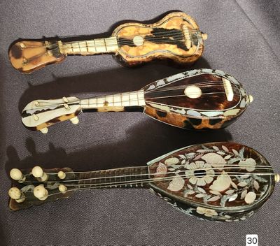 three different types of musical instruments are displayed on a table